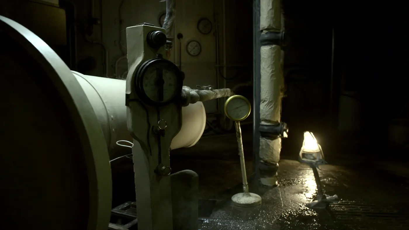 A fuel oil purifier and pipework in a ship's engine room under working lights.